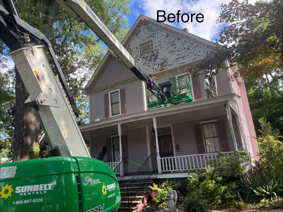 Exterior home project in progress with access equipment in place