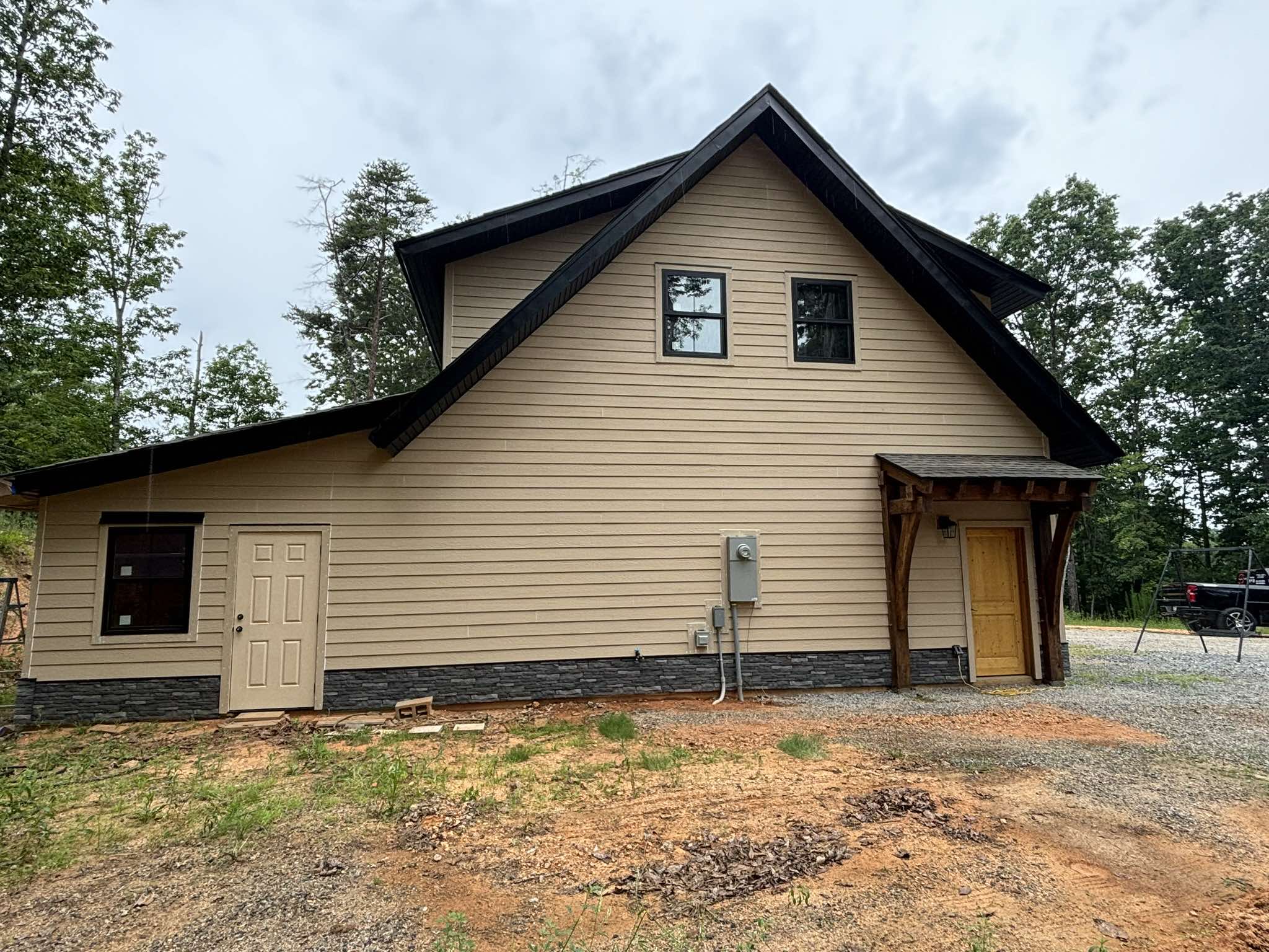 Finished side and rear garage walls with coordinated light siding and dark architectural details