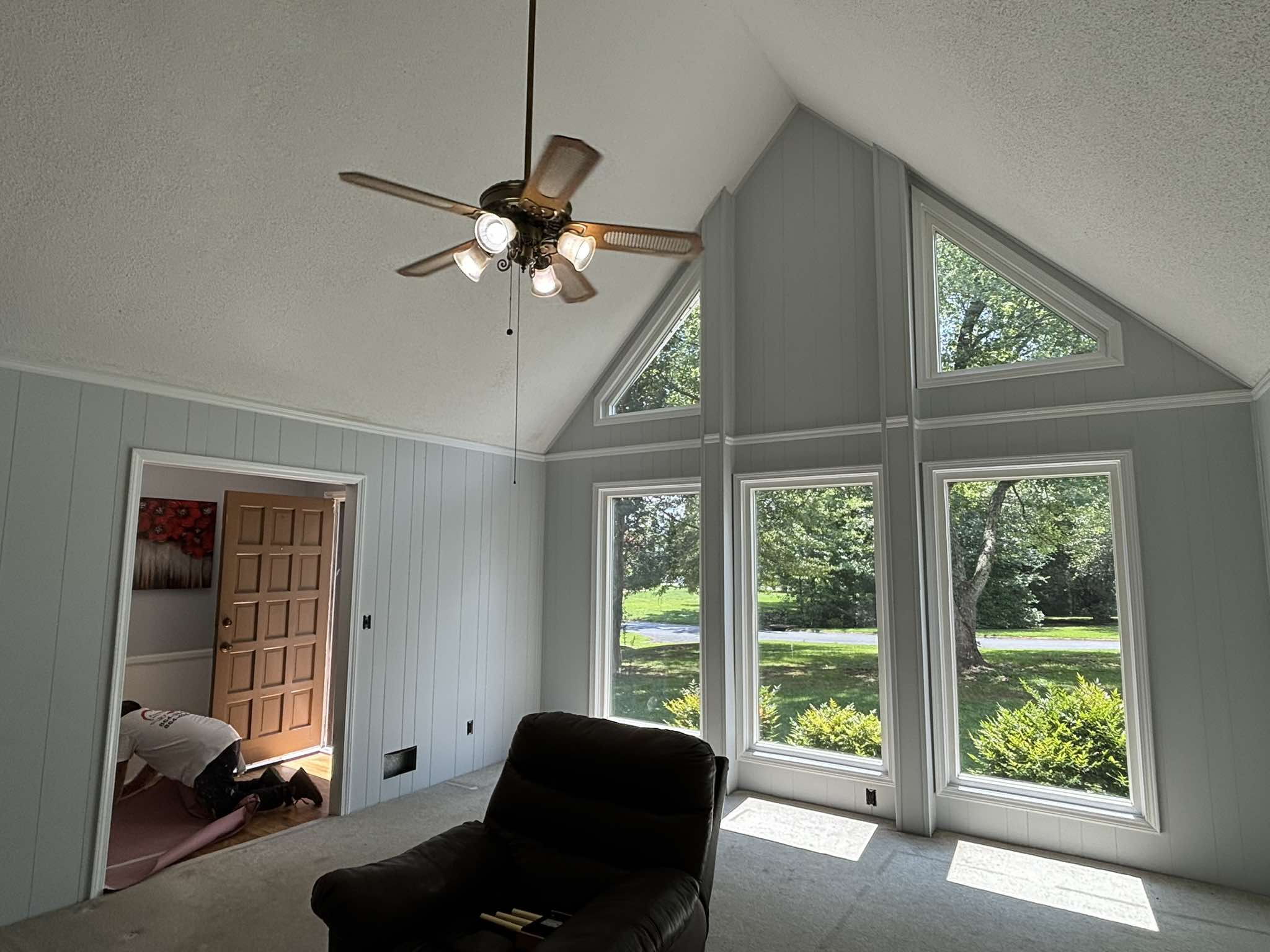 Completed vaulted window wall with soft gray color and bright white trim around every opening